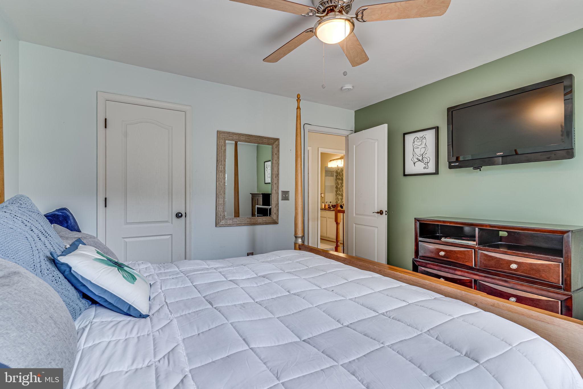 6904 North Stuart Road King George, VA 22485 - Photo 20 of 47 a bedroom with a bed and a flat screen tv