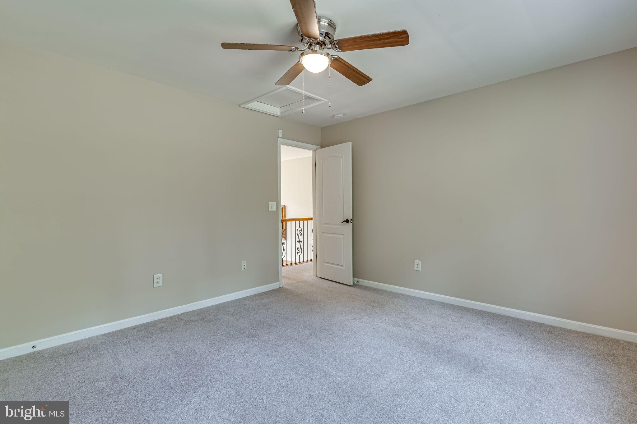 6904 North Stuart Road King George, VA 22485 - Photo 25 of 47 an empty room with a chandelier fan and windows