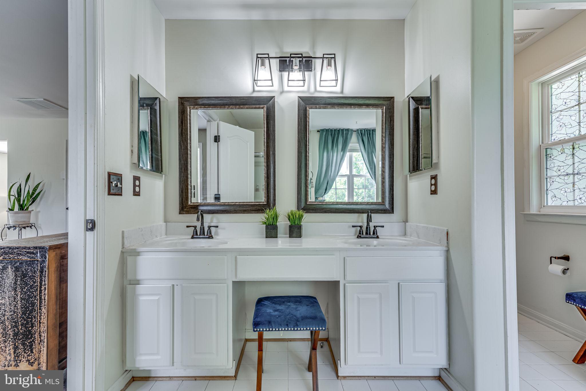 6904 North Stuart Road King George, VA 22485 - Photo 29 of 47 a en suite bathroom with a sink and a mirror