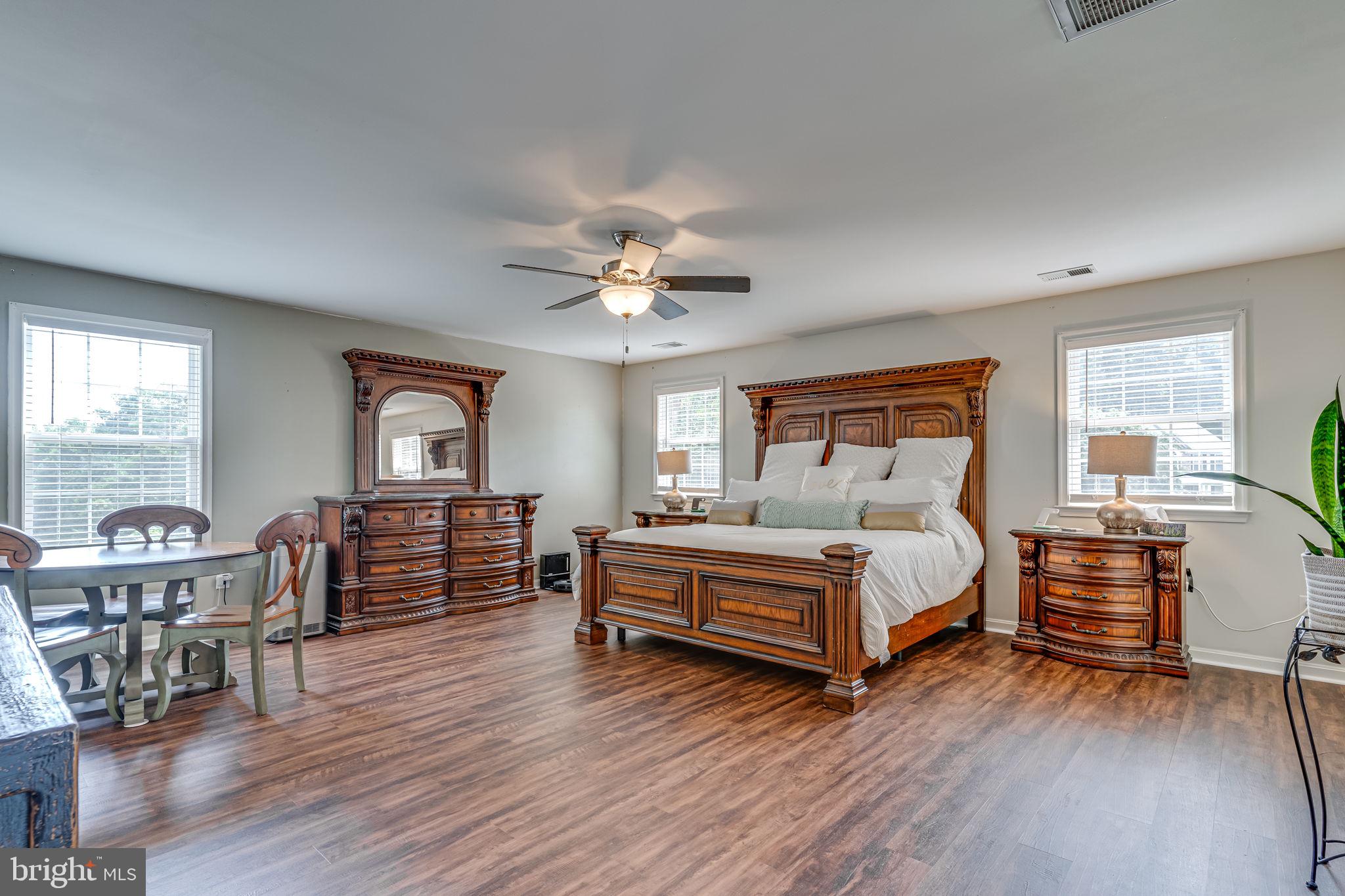 6904 North Stuart Road King George, VA 22485 - Photo 5 of 47 a bedroom with a bed and a chandelier