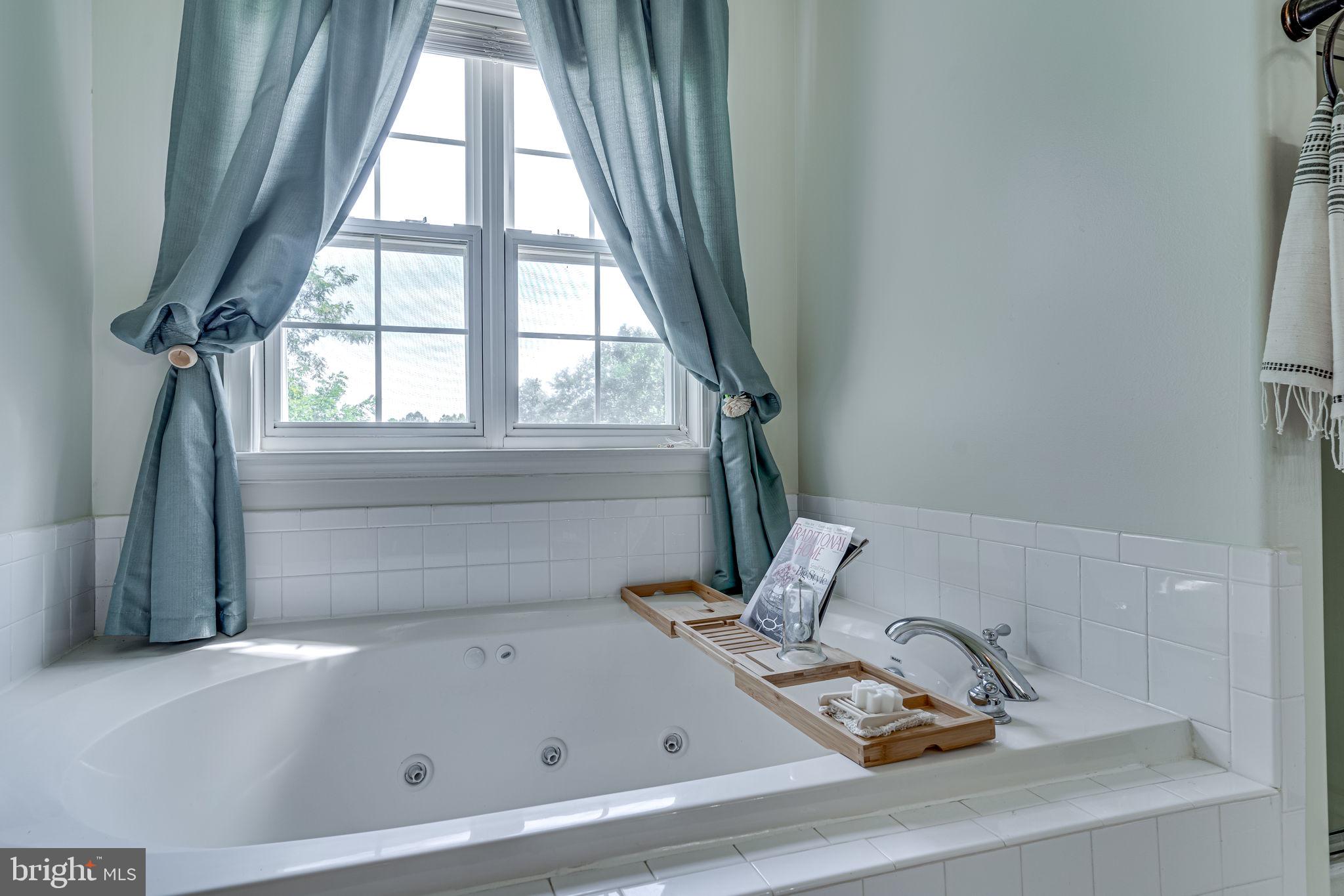 6904 North Stuart Road King George, VA 22485 - Photo 9 of 47 a bathroom with a bathtub and next to a window