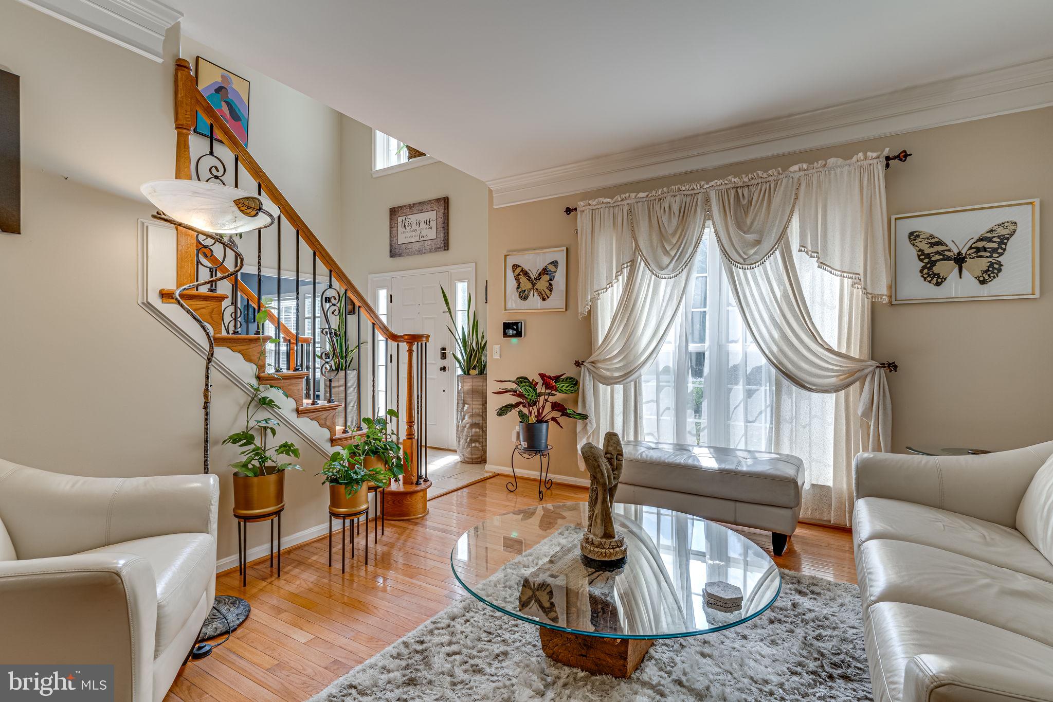 6904 North Stuart Road King George, VA 22485 - Photo 10 of 47 a living room with couches chairs and a dining table with wooden floor