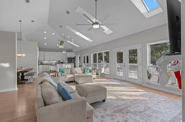 a front view of a house with a garden and trees