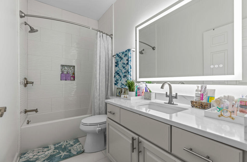 7819 Highway 20 Freeport, FL 32439 - Photo 33 of 75 a bathroom with a granite countertop sink a toilet and shower