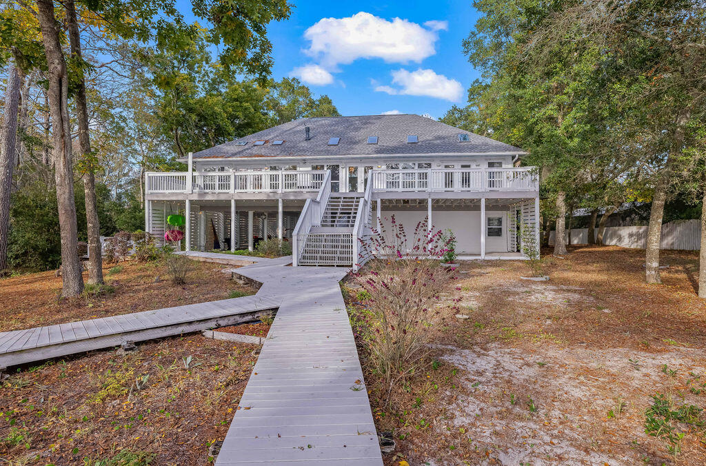 7819 Highway 20 Freeport, FL 32439 - Photo 51 of 75 a front view of a house with a garden and trees