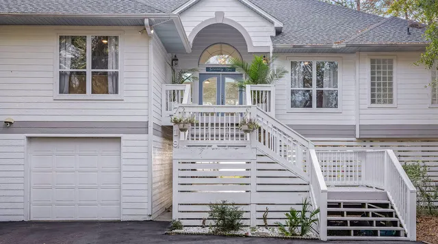 a kitchen with granite countertop a sink stainless steel appliances and cabinets