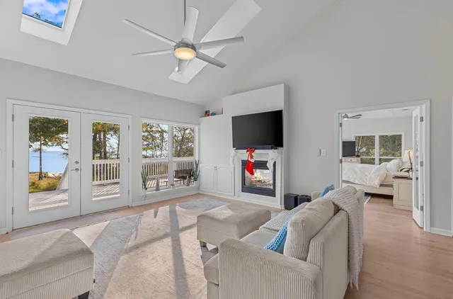 a bedroom with a bed flat screen tv and a window