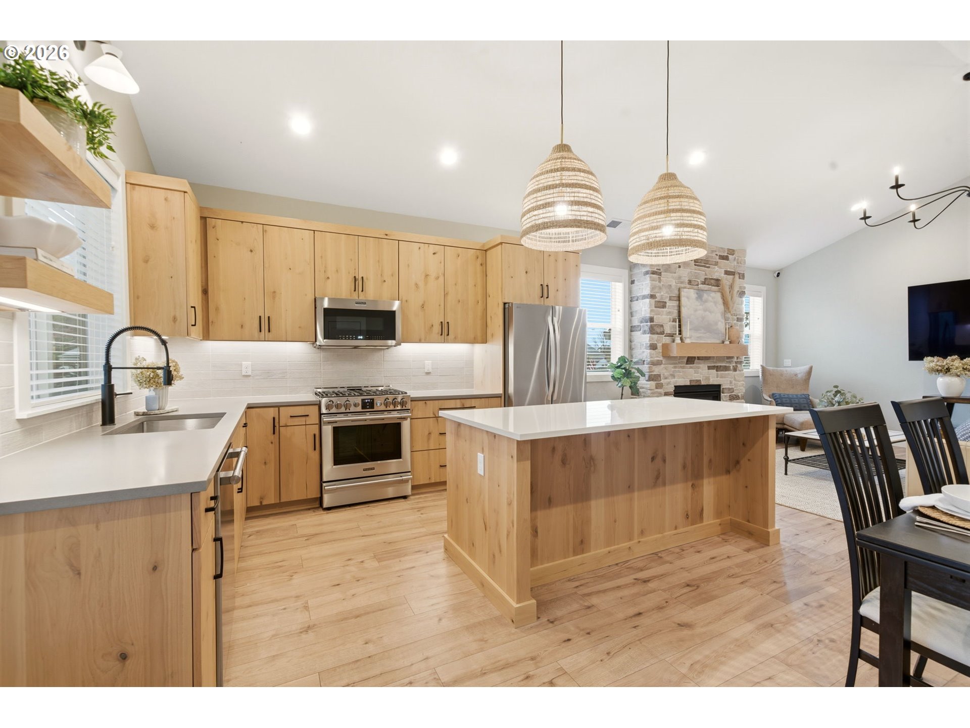 37354 American Street Sandy, OR 97055 - Photo 17 of 37 a kitchen with stainless steel appliances kitchen island granite countertop a sink a stove and a wooden floors