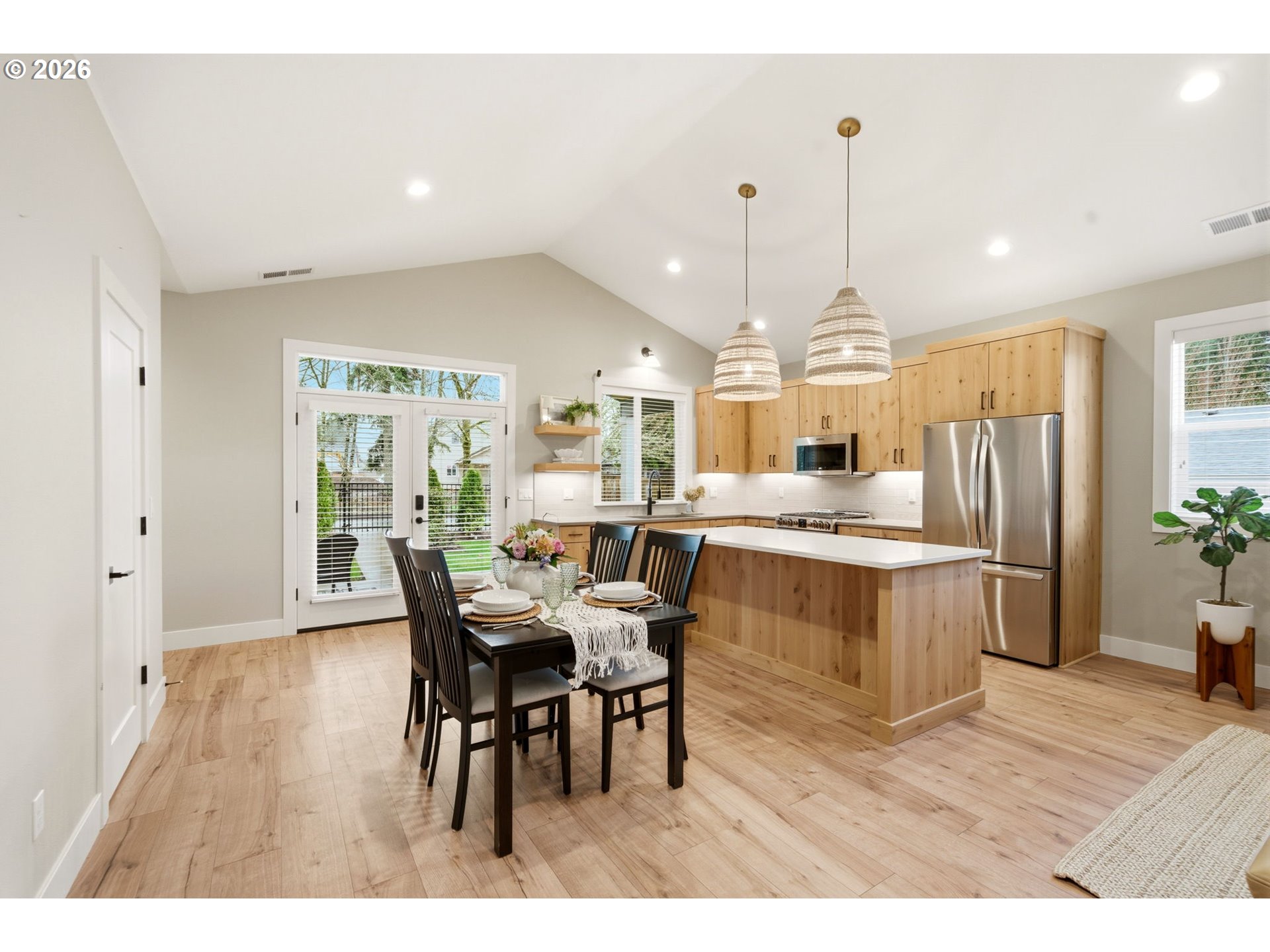 37354 American Street Sandy, OR 97055 - Photo 18 of 37 a kitchen with stainless steel appliances kitchen island granite countertop a refrigerator a stove a sink dishwasher with a dining table and chairs