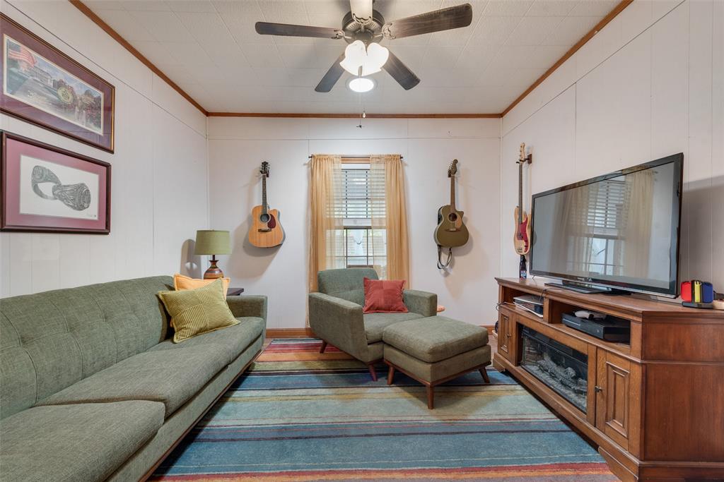 233 East High Street Wills Point, TX 75169 - Photo 15 of 35 Living room with crown molding, a ceiling fan, and wood finished floors