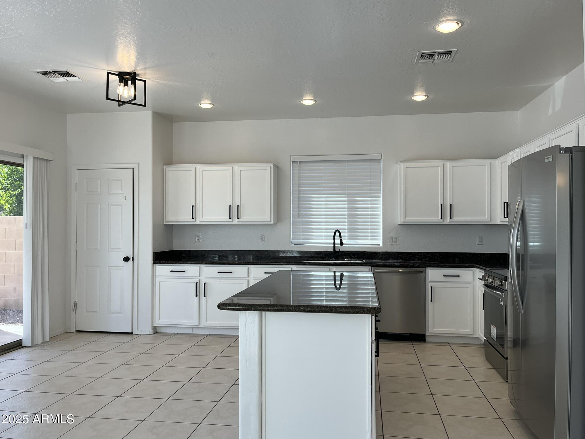 2319 West Alta Vista Road Phoenix, AZ 85041 - Photo 11 of 43 a kitchen with stainless steel appliances granite countertop a refrigerator and a stove