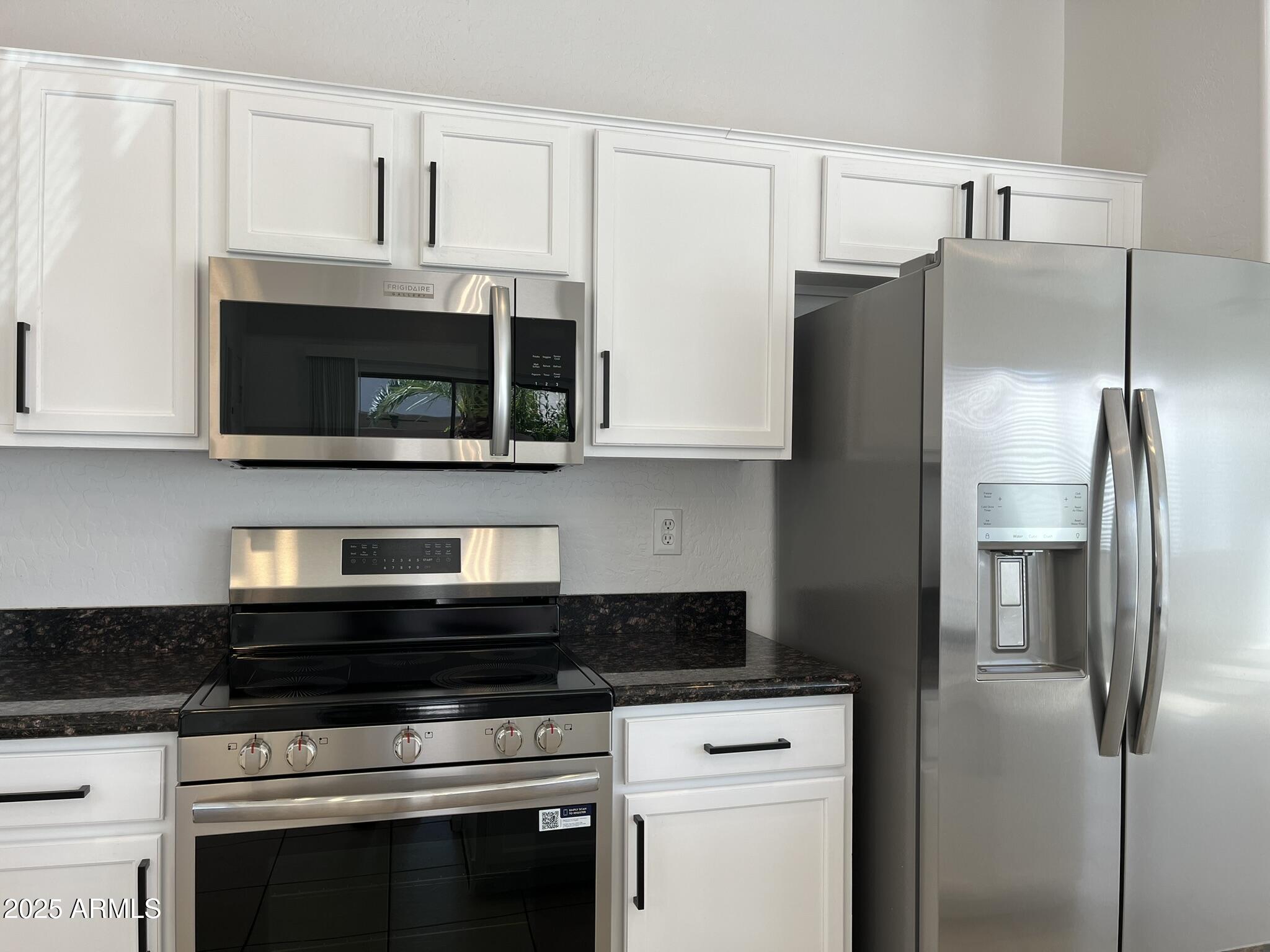 2319 West Alta Vista Road Phoenix, AZ 85041 - Photo 14 of 43 a kitchen with stainless steel appliances granite countertop a refrigerator stove and microwave