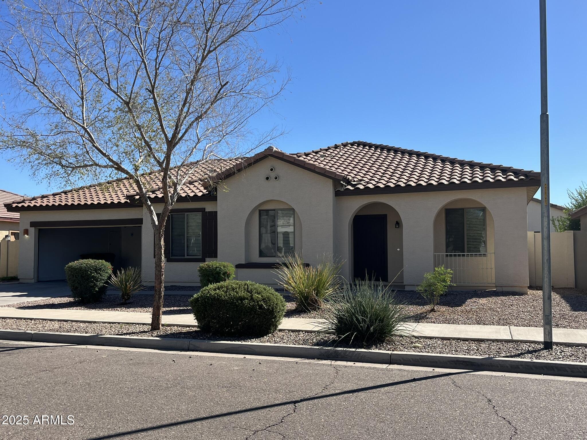 2319 West Alta Vista Road Phoenix, AZ 85041 - Photo 2 of 43 a front view of a house with a garden