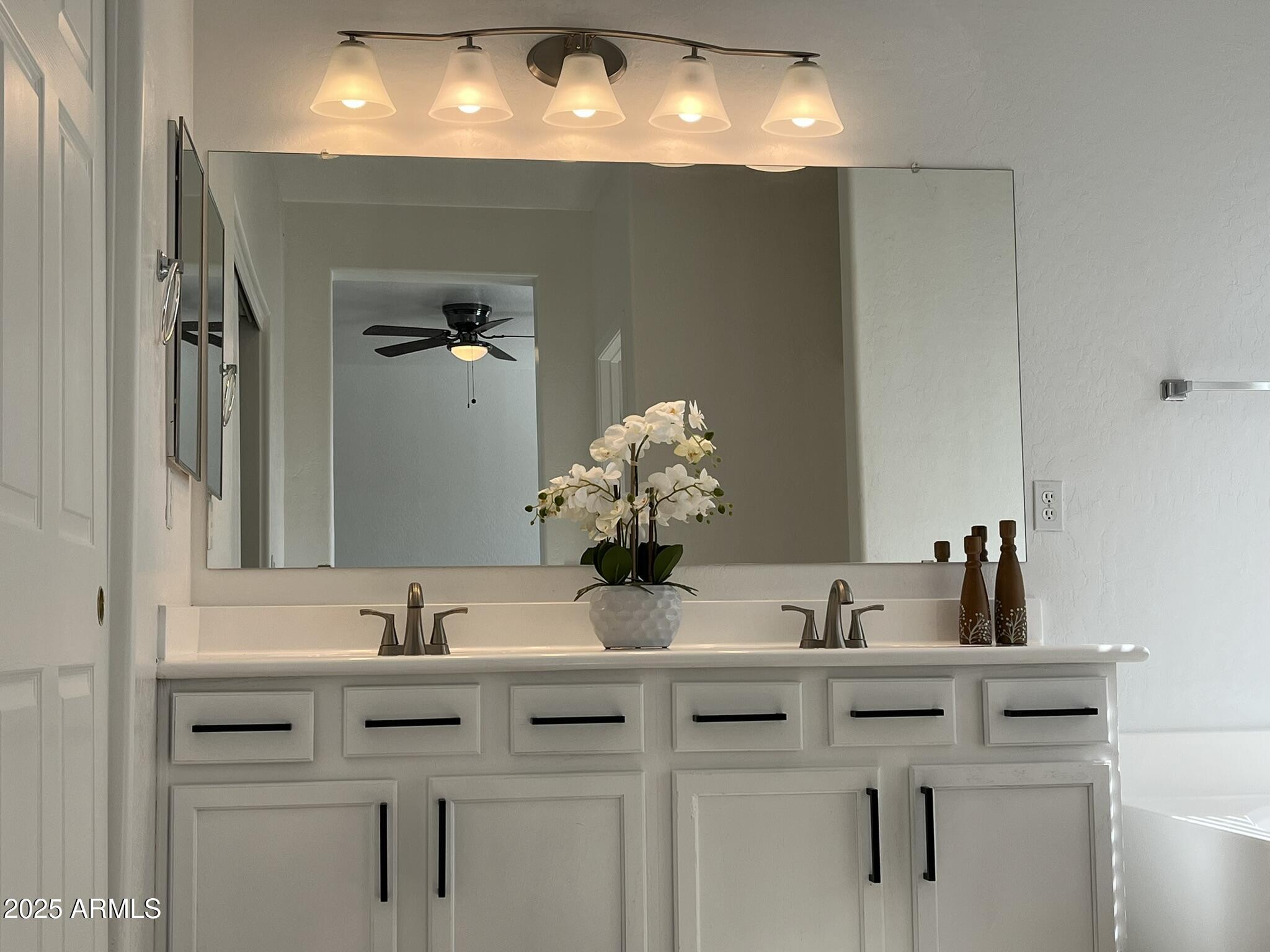 2319 West Alta Vista Road Phoenix, AZ 85041 - Photo 21 of 43 a bathroom with a sink double vanity and a mirror