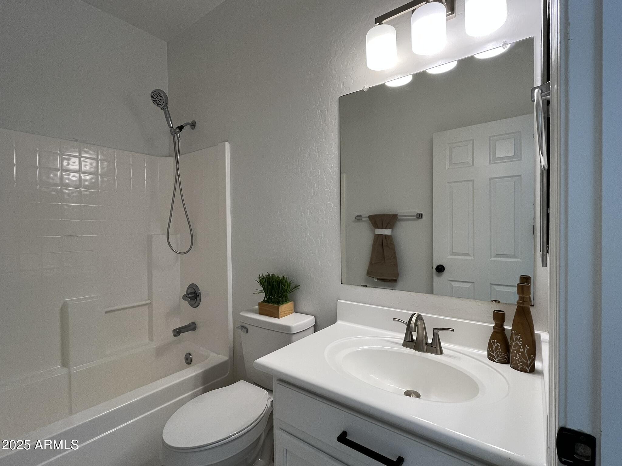 2319 West Alta Vista Road Phoenix, AZ 85041 - Photo 30 of 43 a bathroom with a sink toilet tub and shower