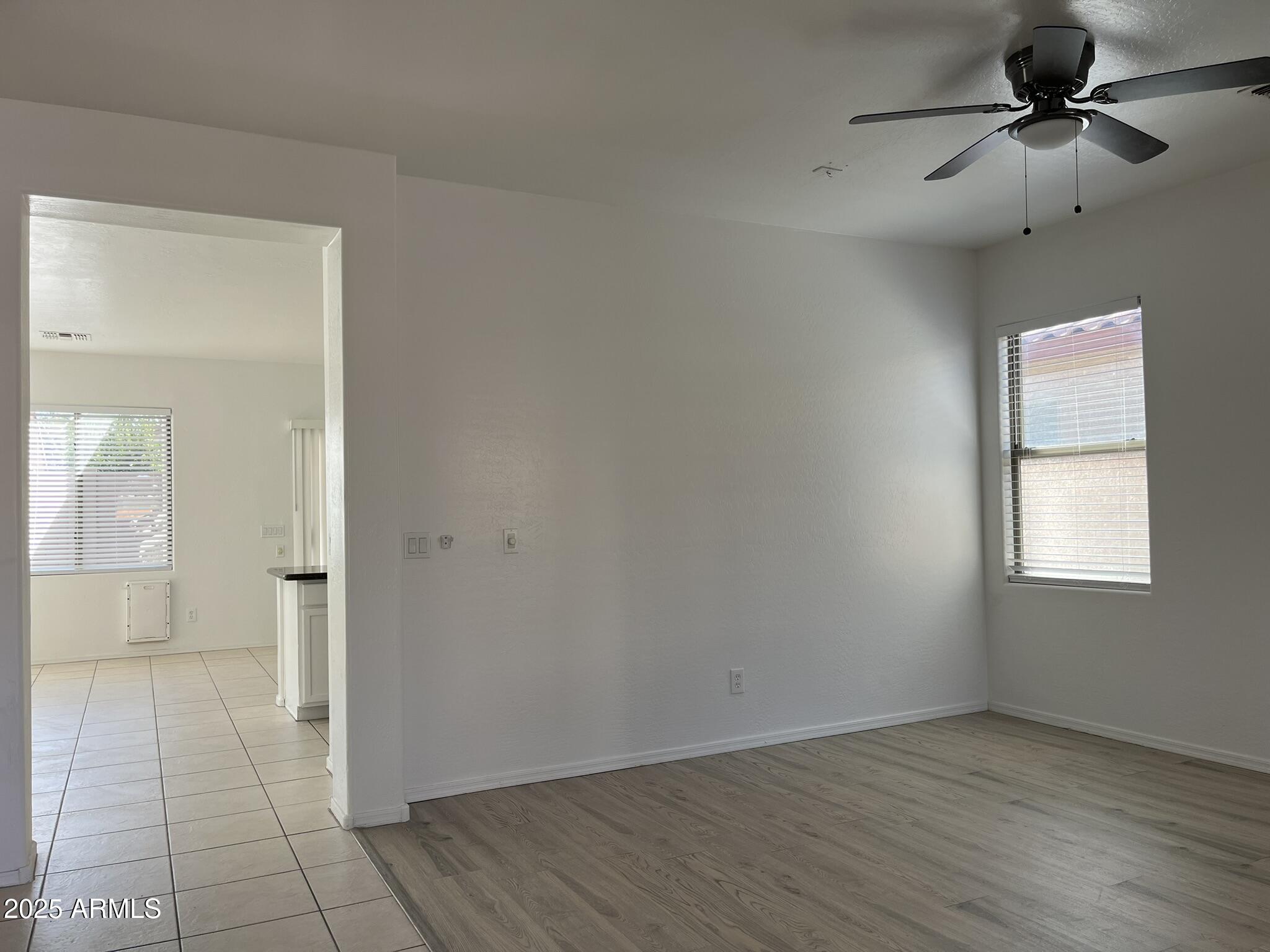 2319 West Alta Vista Road Phoenix, AZ 85041 - Photo 4 of 43 wooden floor in an empty room with a window