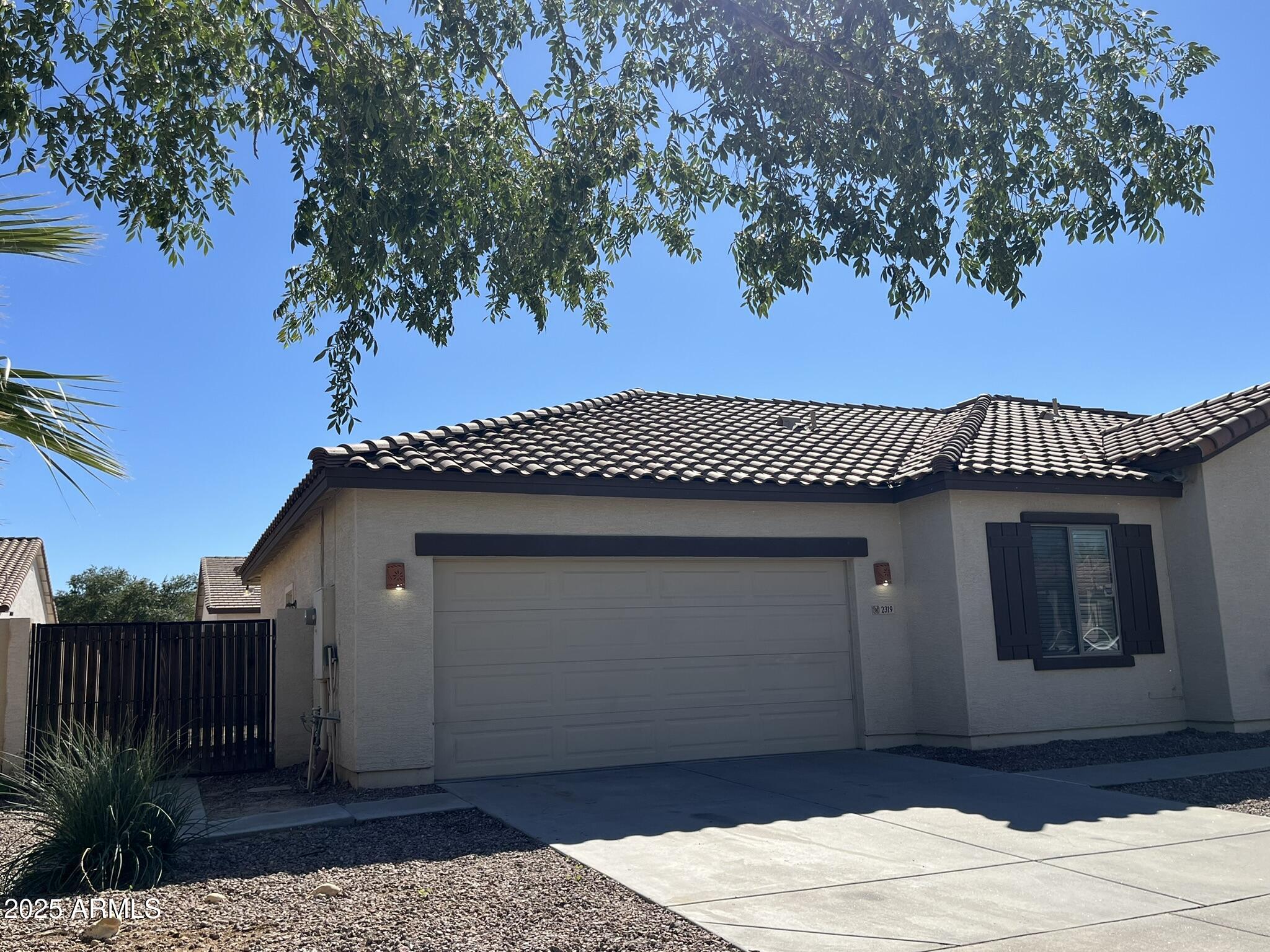2319 West Alta Vista Road Phoenix, AZ 85041 - Photo 42 of 43 a front view of a house with a garden