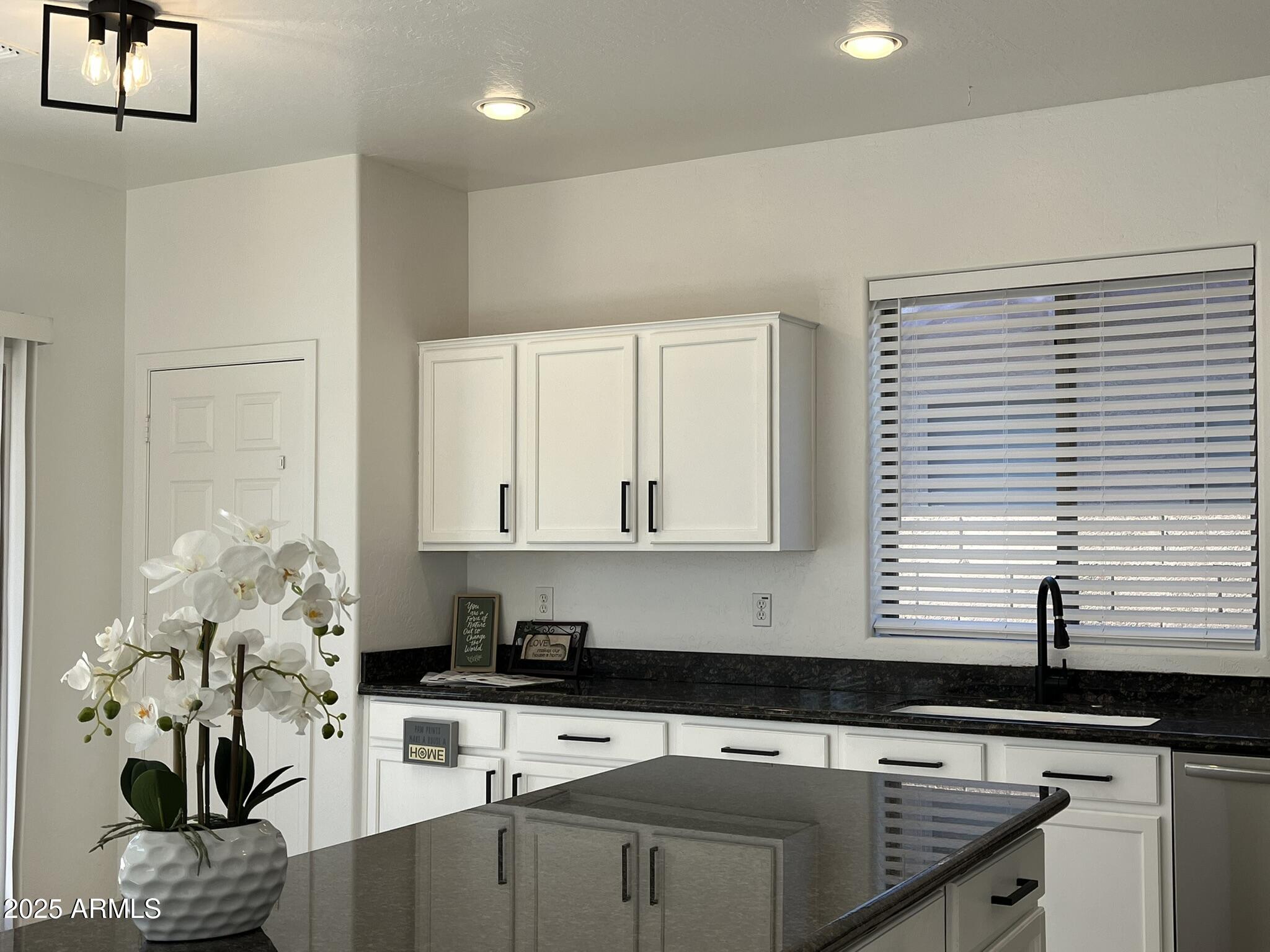 2319 West Alta Vista Road Phoenix, AZ 85041 - Photo 8 of 43 a kitchen with stainless steel appliances granite countertop a sink a window and cabinets