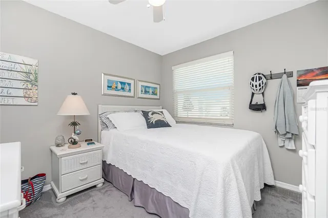 a spacious bedroom with a bed and a window