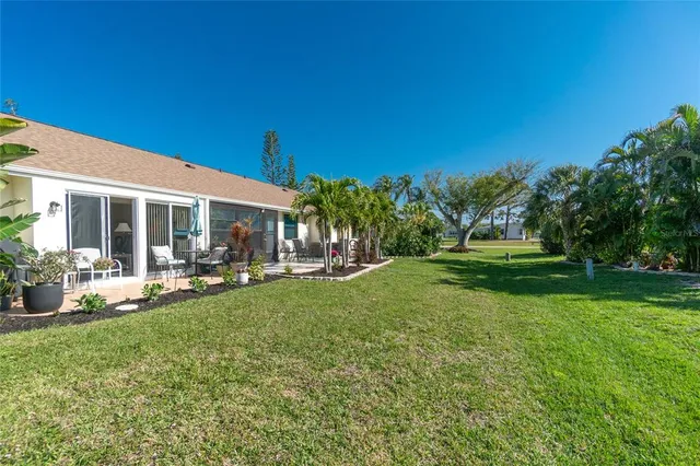 a view of a house with backyard porch and sitting area