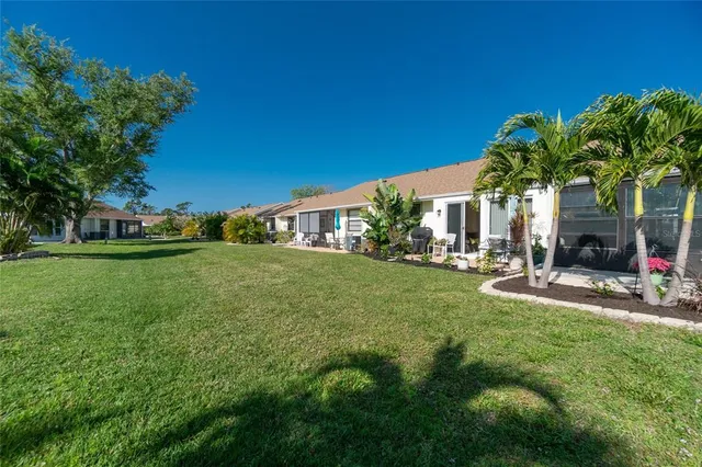 a view of backyard of house with green space