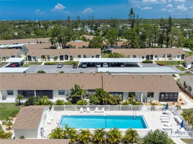 an aerial view of a house with a swimming pool yard and outdoor seating