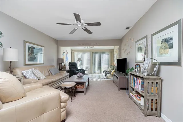 a living room with furniture a flat screen tv and a window