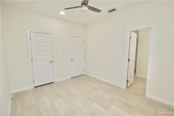 an empty room with a ceiling fan