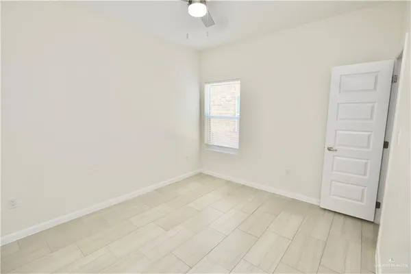 an empty room with windows and closet