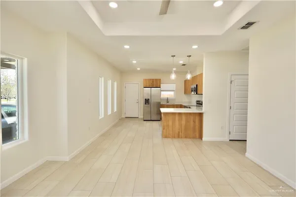a large kitchen with a lot of counter top space and stainless steel appliances