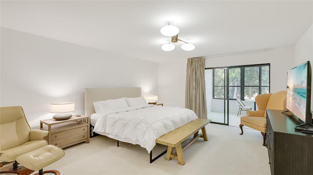 303 Springdale Drive, Unit 303 Bradenton, FL 34210 - Photo 13 of 23 a bedroom with a bed and large mirror