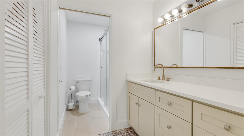 303 Springdale Drive, Unit 303 Bradenton, FL 34210 - Photo 16 of 23 a bathroom with a sink a toilet and a mirror