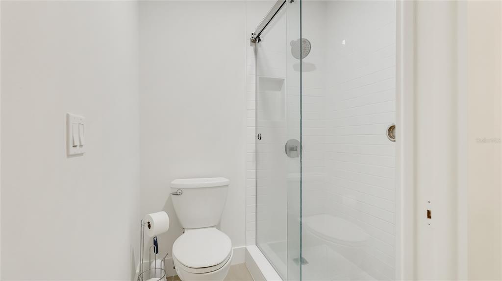 303 Springdale Drive, Unit 303 Bradenton, FL 34210 - Photo 17 of 23 a bathroom with a toilet and a shower