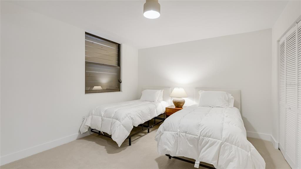 303 Springdale Drive, Unit 303 Bradenton, FL 34210 - Photo 18 of 23 a bedroom with two beds and a night stand