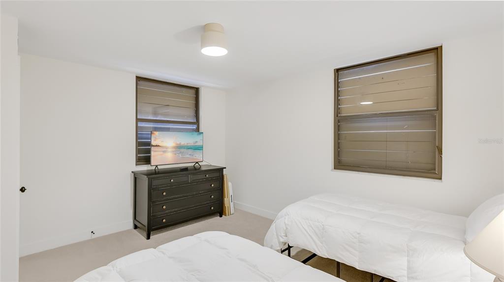 303 Springdale Drive, Unit 303 Bradenton, FL 34210 - Photo 19 of 23 a bedroom with a bed and a dresser