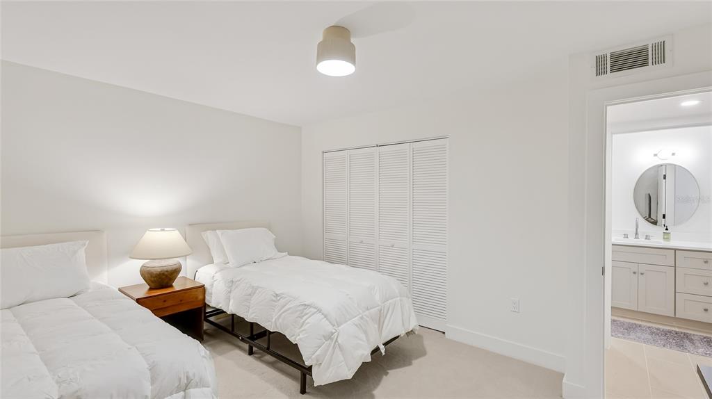 303 Springdale Drive, Unit 303 Bradenton, FL 34210 - Photo 20 of 23 a bedroom with a bed and a lamp