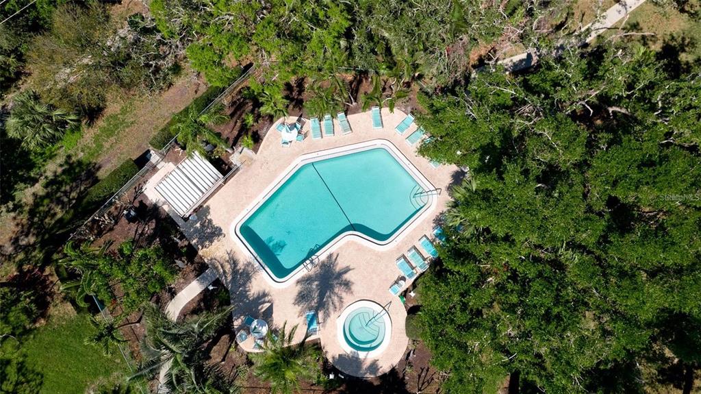 303 Springdale Drive, Unit 303 Bradenton, FL 34210 - Photo 22 of 23 an aerial view of a house with a swimming pool and outdoor space