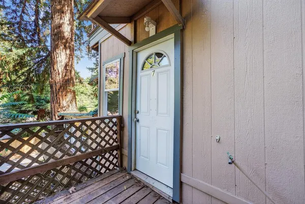 a view of a small room with wooden floor and iron fence