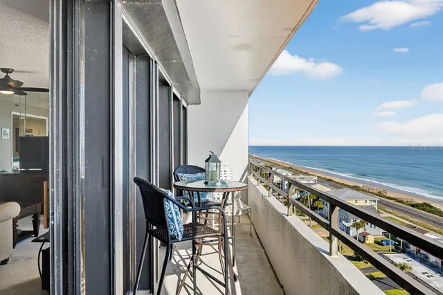 a view of a chairs and table in a balcony