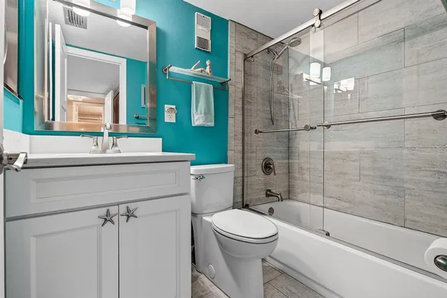 a bathroom with a sink mirror toilet and shower
