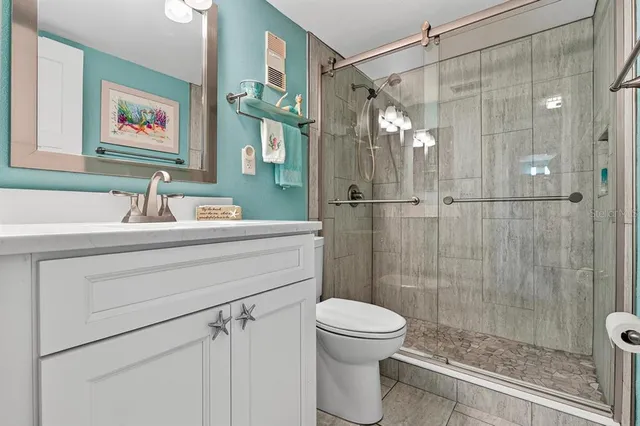 a bathroom with a sink toilet and shower