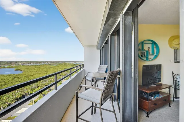 a city view from a balcony with chairs