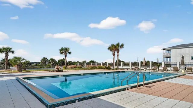 a view of a swimming pool with outdoor seating