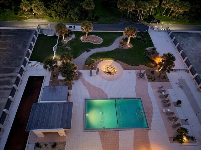 an aerial view of a house with yard swimming pool and outdoor seating