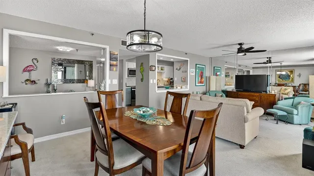 a view of a dining room with furniture wooden floor and chandelier