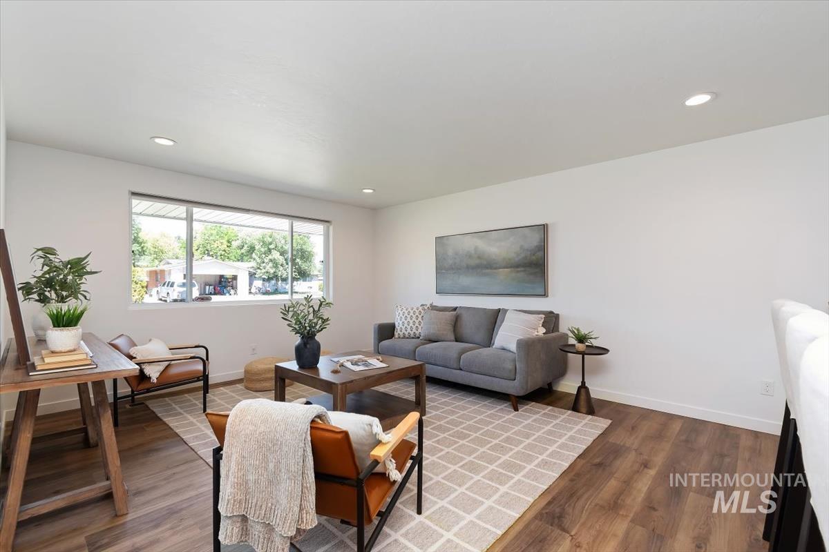 2217 North Middlefield Road Boise, ID 83704 - Photo 6 of 34 Bright living area featuring wood-finish flooring, recessed lighting, a large picture window, and white wall finishes