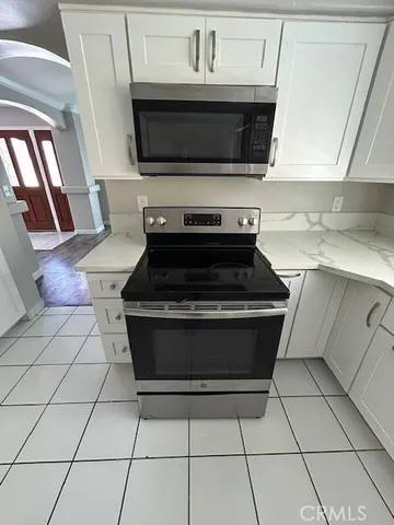 a stove top oven sitting inside of a kitchen
