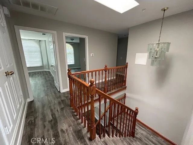 a view of staircase with wooden floor and white walls