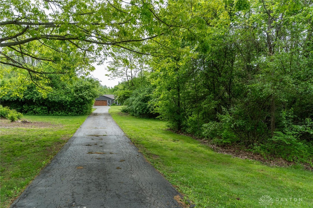 2165 Stewart Road Xenia, OH 45385 - Photo 55 of 59 A long, private driveway leads to a secluded residence nestled among lush greenery.