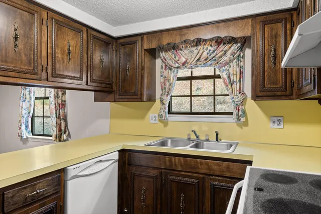 a kitchen with a sink and a window